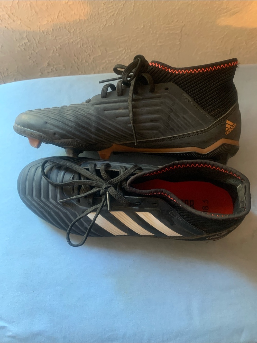 adidas boys Black Soccer Cleats with White Stripes and Orange Accents